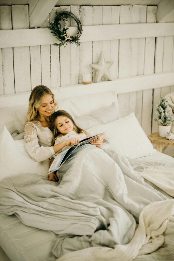 mother reading a book with girl
